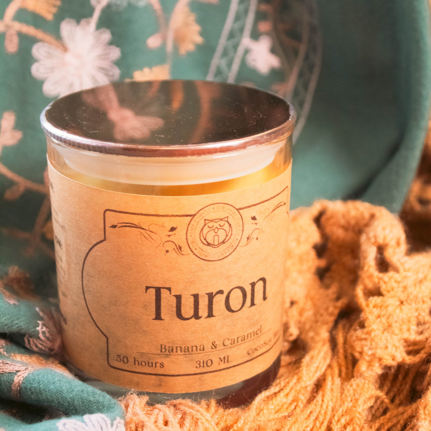 Candle labeled 'Turon' with decorative background