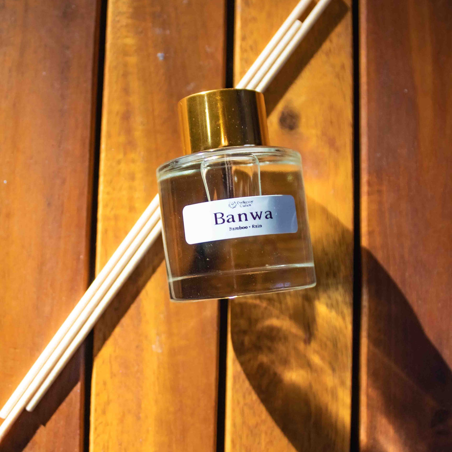 Banwa diffuser bottle with wooden sticks on a wooden surface