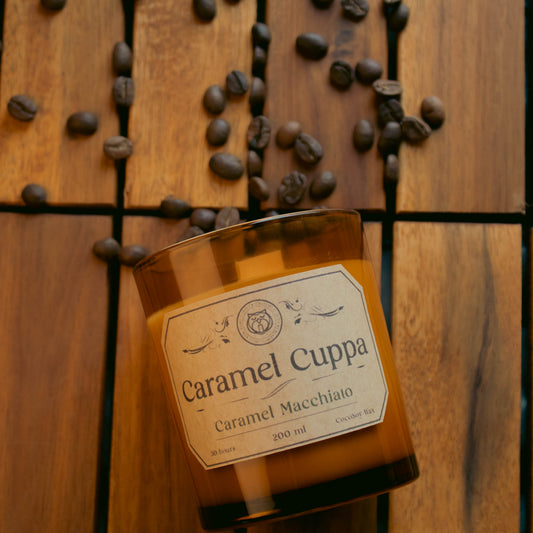 Caramel Cuppa Caramel Macchiato bottle on a wooden surface with coffee beans.