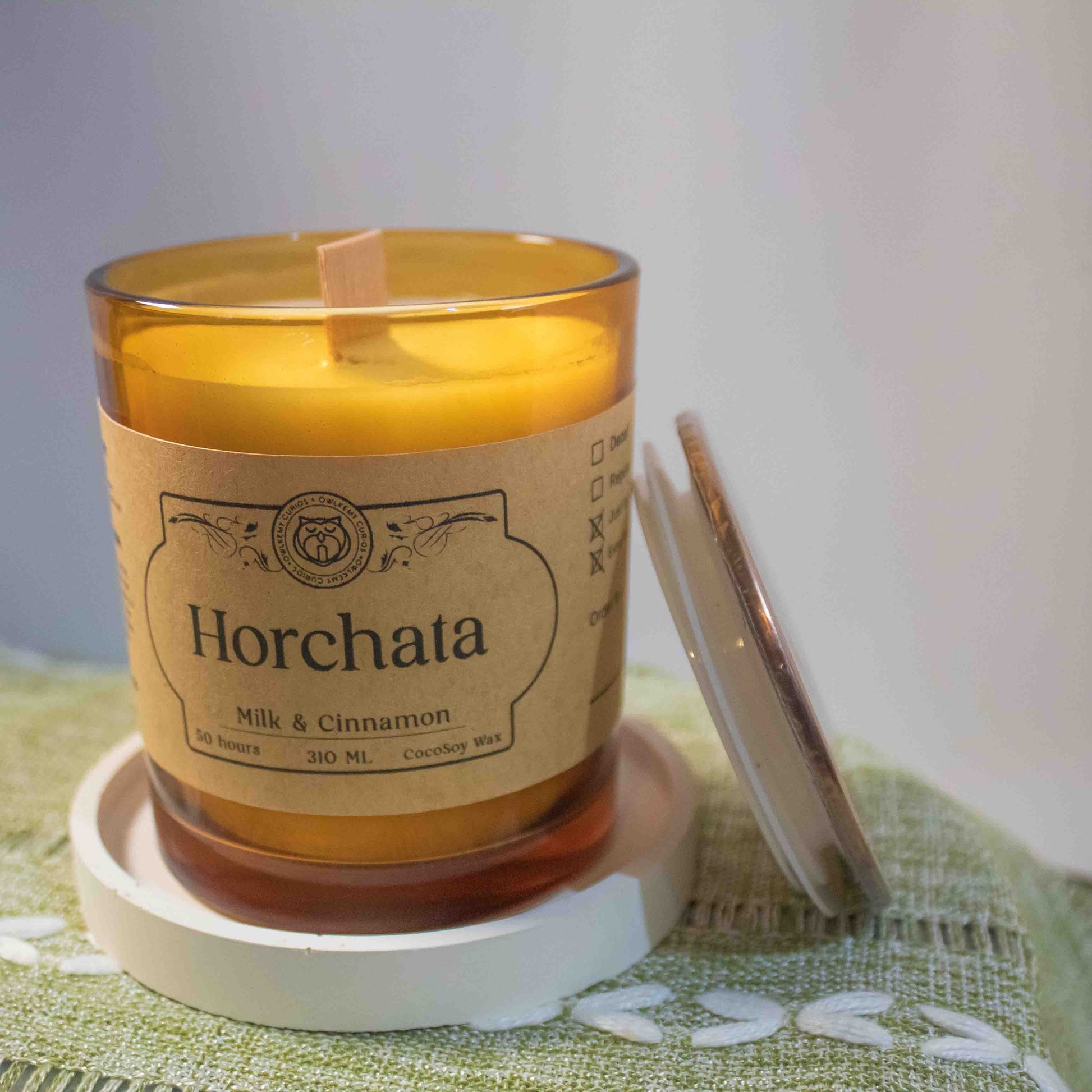 Horchata candle with a label on a green textured surface