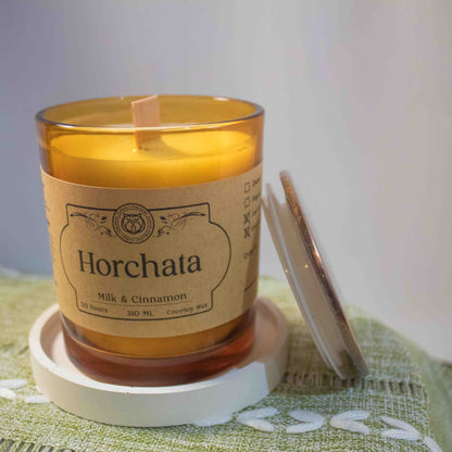 Horchata candle with a label on a green textured surface