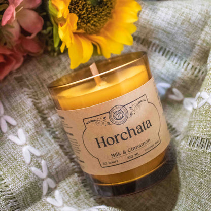 Horchata candle with a sunflower and flowers on a textured surface